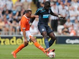 Newcastle United's Moussa Sissoko and Blackpool's Michael Chopra battle for the ball during a friendly match on July 28, 2013