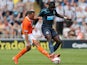 Newcastle United's Moussa Sissoko and Blackpool's Michael Chopra battle for the ball during a friendly match on July 28, 2013