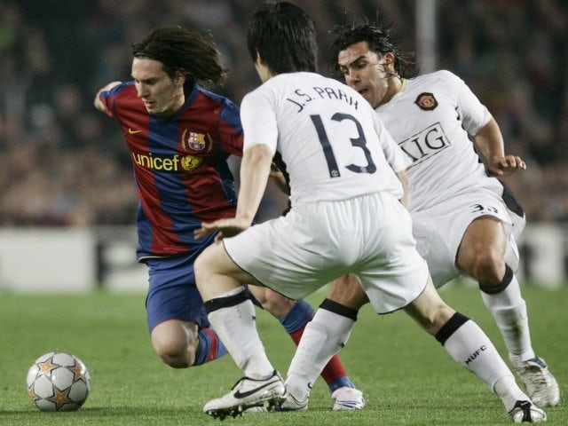 Park Ji-Sung attempts to tackle Lionel Messi.