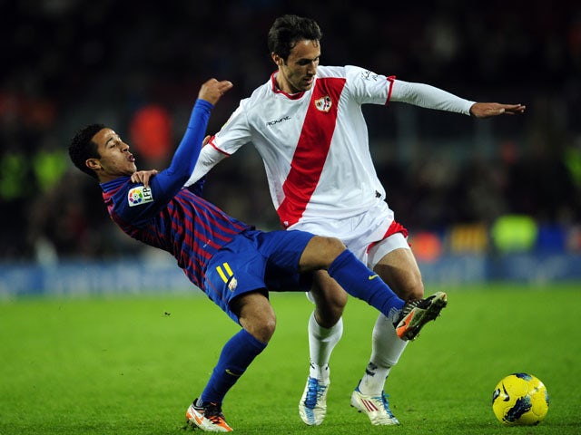 Rayo Vallecano's Rafa Garcia duels for the ball with  FC Barcelona's Thiago Alcantara during the La Liga match on November 29, 2011