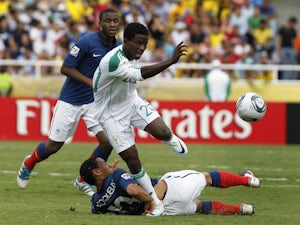Nigeria's Ramon Azeez runs over France's Francis Coquelin during a U-20 World Cup on August 14, 2011