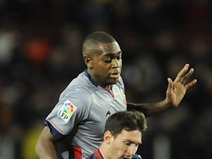 Osasuna's Raoul Loe fights for the ball with Barcelona's Lionel Messi on January 27, 2013