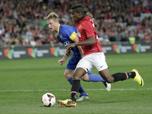 Manchester United Wilfried Zaha, right, controls the ball past Sydney Allstars' Rhyan Grant during a friendly match on July 20, 2013