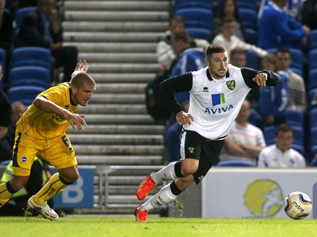 Norwich City's Gary Hooper gets away from Brighton & Hove Albion's Adam El-Abd during the friendly match on July 30, 2013