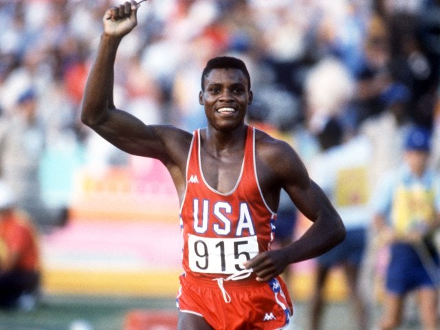 Carl Lewis celebrates winning gold at the 1984 Olympic Games.