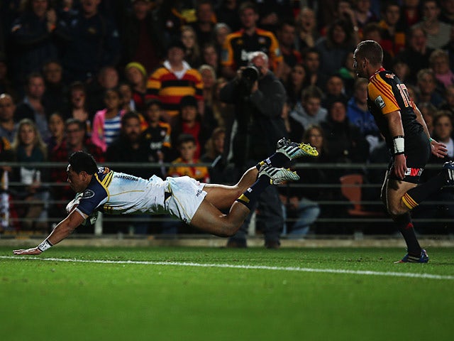 Brumbies' Christian Lealiifano dives in to score a try against the Chiefs during the Super Rugby Final on August 3, 2013