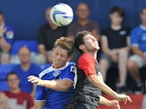 Huddersfield Town's Cristian Lopez out jumps Oldham Athletic's James Tarkowski during a friendly match on May 27, 2013