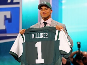 New York Jets' Dee Milliner holds up his jersey on April 25, 2013