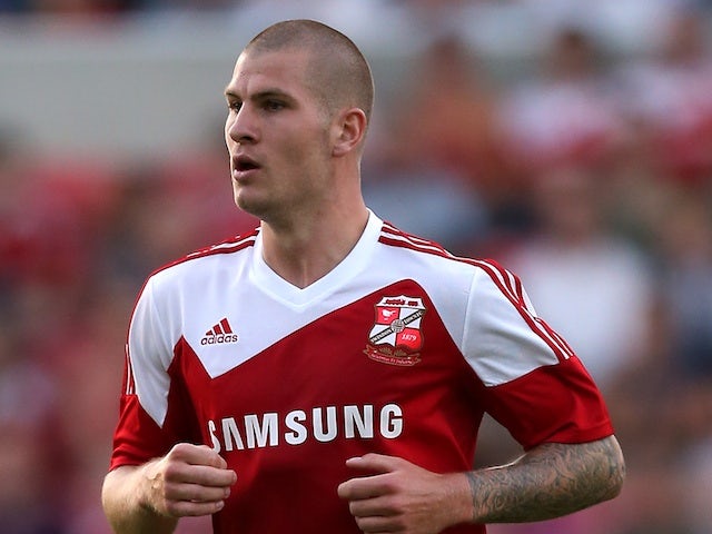Swindon's James Collins in action against Tottenham on July 16, 2013