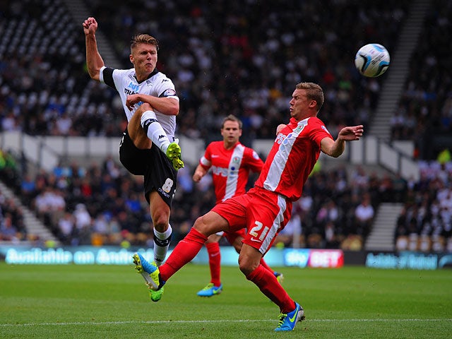 Derby's Jeff Hendrick and Blackburn Alex Marrow battle for the ball on August 4, 2013