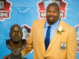 Dallas Cowboys' Larry Allen poses with his Hall of Fame bust during the NFL Class of 2013 Enshrinement Ceremony on August 3, 2013