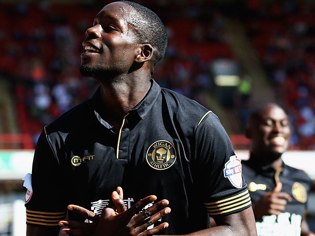 Wigan's Leon Barnett celebrates after scoring his team's third goal during the match against Barnsley on August 3, 2013
