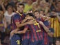 Barcelona's Lionel Messi celebrates with teammates on August 2, 2013