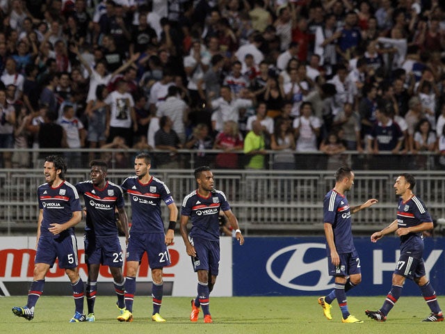 Lyon's Milan Bisevac celebrates scoring against Grasshopper Zurich with his teammates during their Champions League qualifying match on July 30, 2013