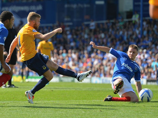 Alfie Potter of Oxford scores his side's third goal during the Sky Bet League Two match between Portsmouth and Oxford United on August 3, 2013
