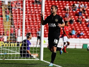 Wigan's Shaun Maloney celebrates after scoring his team's fourth goal against Barnsley on August 3, 2013