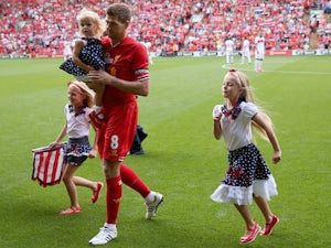 Steven Gerrard of Liverpool walks his three daughters of the pitch prior to the Steven Gerrard Testimonial Match on August 3, 2013