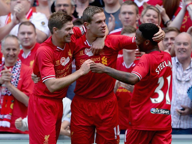 Jordan Henderson of Liverpool is congratulated by Steven Gerrard and Raheem Sterling after scoring the winning goal during the Steven Gerrard Testimonial Match on August 3, 2013