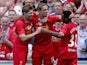 Jordan Henderson of Liverpool is congratulated by Steven Gerrard and Raheem Sterling after scoring the winning goal during the Steven Gerrard Testimonial Match on August 3, 2013