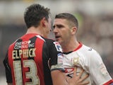 Bournemouth captain Tommy Elphick confronts MK Dons striker Ryan Lowe.
