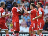 Southampton's Adam Lallana is congratulated by team mates after scoring against Real Sociedad during a friendly match on August 10, 2013