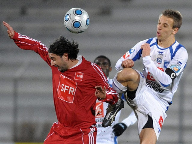 Auxerre's Benoit Pedretti and Ajaccio's Ludovic Asuarl battle for the ball on January 3, 2009