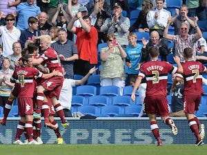 Derby's Chris Martin is mobbed by team mates after scoring his second goal against Brighton on August 10, 2013