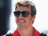 Ferrari driver Fernando Alonso smiles ahead of the final practise session of the Hungarian Grand Prix on July 27, 2013