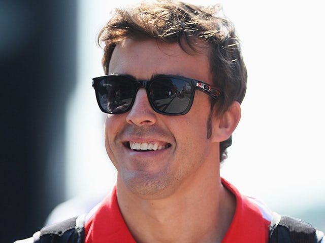 Ferrari driver Fernando Alonso smiles ahead of the final practise session of the Hungarian Grand Prix on July 27, 2013