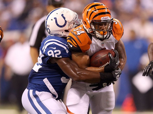 Jerry Hughes of the Indianapolis Colts tackles Daniel Herron of the Cincinnati Bengals on August 30, 2012