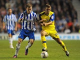 Ashley Barnes of Brighton challenges Joe Mattock of Sheffield Wednesday during the npower Championship match between Brighton & Hove Albion and Sheffield Wednesday at Amex Stadium on September 14, 201
