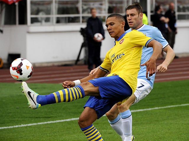 Arsenal's Kieran Gibbs and Manchester City's James Milner battle for the ball during a friendly match on August 10, 2013