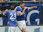 Schalke's Klaas-Jan Huntelaar is congratulated by team mate Christian Fuchs after scoring his second goal against Hamburg on August 11, 2013