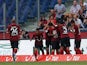 Hannover's Leon Andreasen is mobbed by his team mates after scoring the opening goal against Wolfsburg on August 10, 2013
