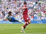 Brighton's Leonardo Ulloa heads in the opening goal against Derby on August 10, 2013