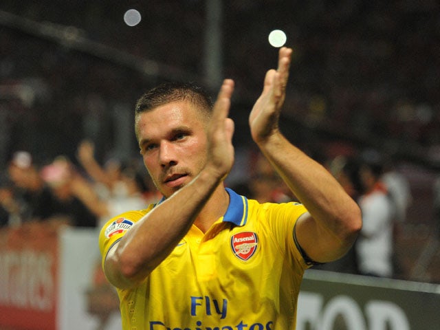 Lukas Podolski of Arsenal FC greet the fans after the match between Arsenal and the Indonesia All-Stars on July 14, 2013