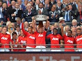 Manchester United's Nemanja Vidic lifts the Community Shield after beating Wigan 2-0 at Wembley on August 11, 2013