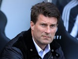 Swansea City's Danish manager Michael Laudrup takes his seat in the dugout prior to the English Premier League football match between Swansea City and Southampton on April 20, 2013