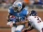 Mikel Leshoure of the Detroit Lions tries to get around the tackle of Anthony Walters of the Chicago Bears on December 30, 2012