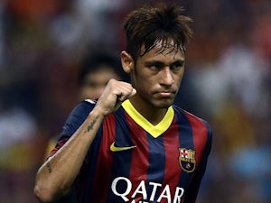 Barcelona's Neymar celebrates after scoring his team's second goal against Malaysia XI during a friendly match on August 10, 2013