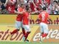 Mainz' Nicolai Mueller is congratulated by team mates after scoring the opening goal against Stuttgart on August 11, 2013