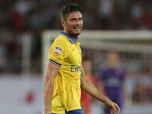Arsenal striker Oliver Giroud reacts afetr missing a shot at goal against Vietnam during the international friendly match between Vietnam and Arsenal FC at My Dinh National Stadium on July 17, 2013