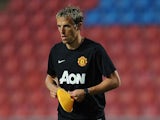 Coach Phil Neville lays out marker cones during a Manchester United training session at Rajamangala Stadium on July 12, 2013