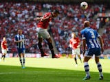 Manchester United striker Robin van Persie heads in the opener against Wigan Athletic in the Community Shield on August 11, 2013