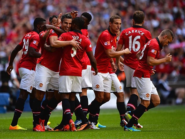 Manchester United's Robin Van Persie is congratulated by team mates after scoring the opening goal against Wigan during the Community Shield on August 11, 2013