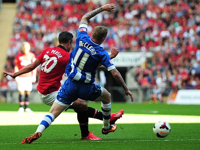 Manchester United's Robin Van Persie scores his team's second goal against Wigan during the Community Shield on August 11, 2013