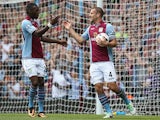 Villa's Ron Vlaar is congratulated by team mate Christian Benteke after scoring his team's second goal against Malaga during a friendly match on August 10, 2013