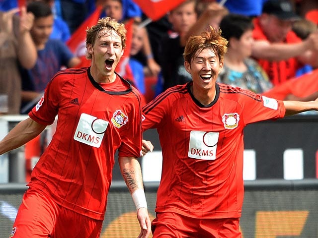 Leverkusen's Stefan Kiessling is congratulated by team mate Heung Min Son after scoring against Freiburg on August 10, 2013