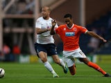 Blackpool's Tom Ince and Preston's Keith Keane battle for the ball during their League Cup match on August 5, 2013