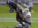 Adam Replogle #98 of the Indiana Hoosiers tackles Venric Mark #5 of the Northwestern Wildcats at Ryan Field on September 29, 2012